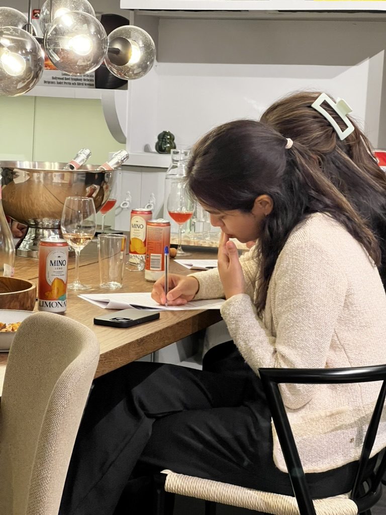A woman writing in her workbook during an evening session